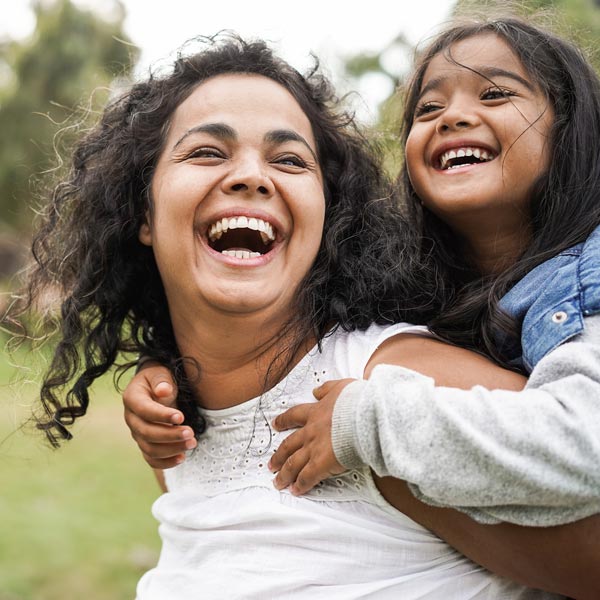 smiling mother and young daughter