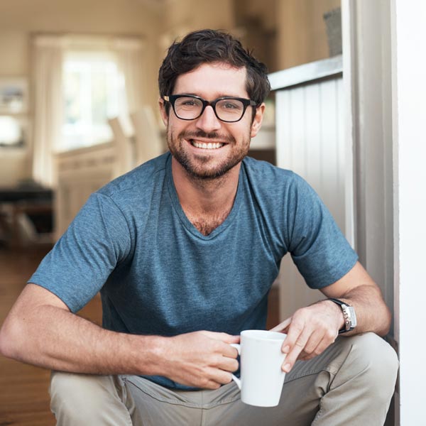 smiling man with coffee cup