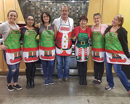 Dr. Corbet wearing christmas apron